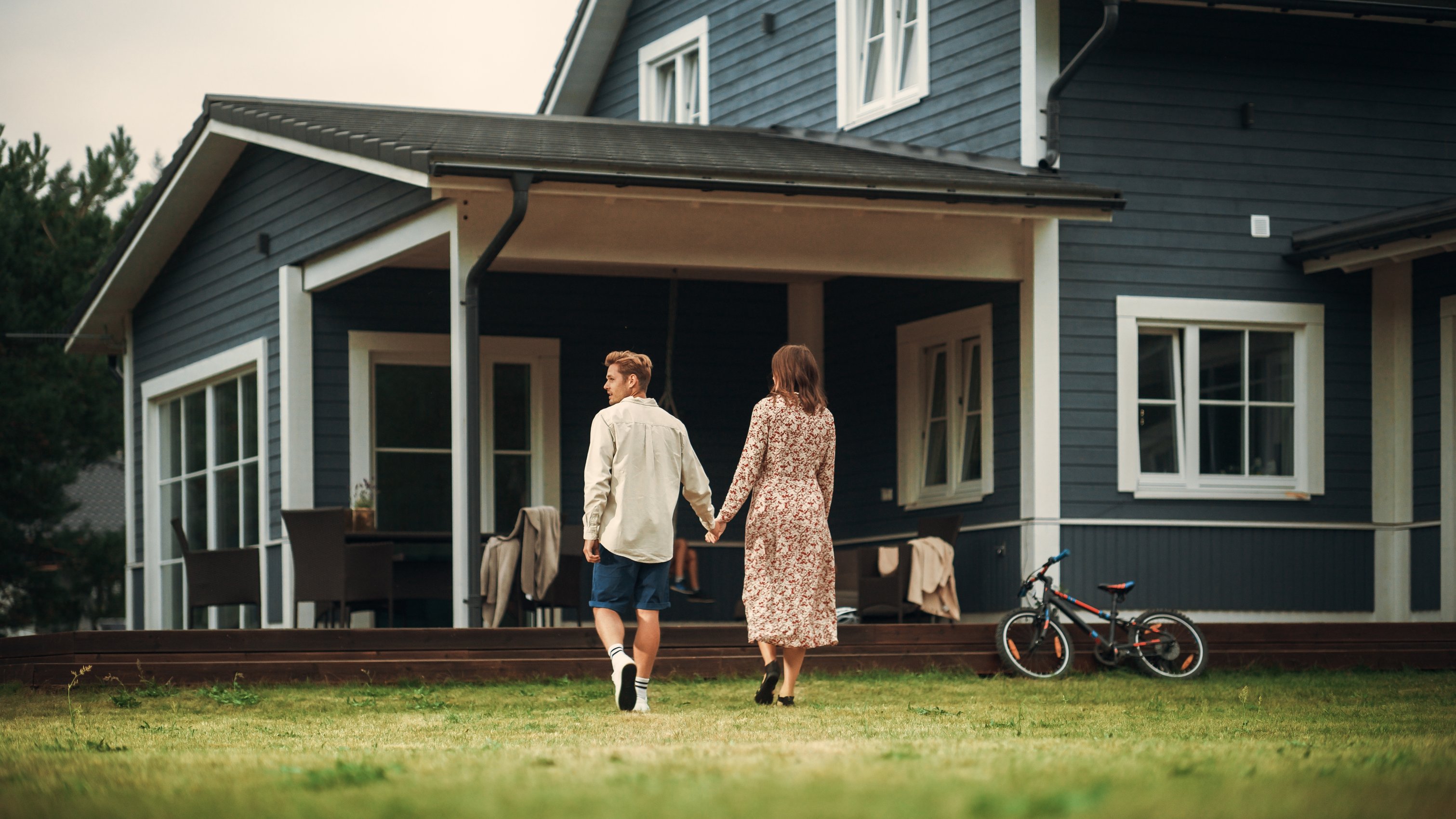 Couple in front of house