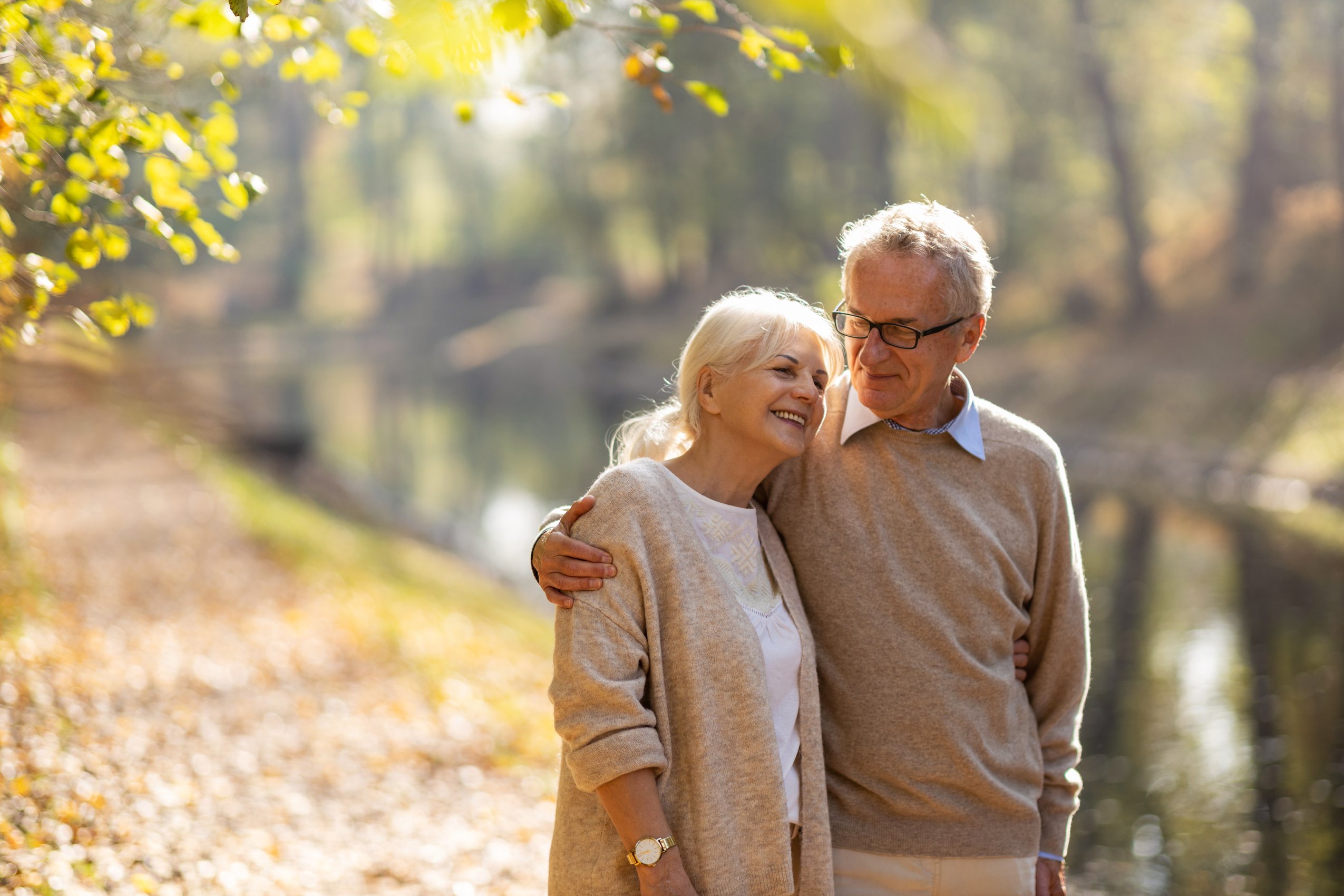 happy retired couple outside on a trail