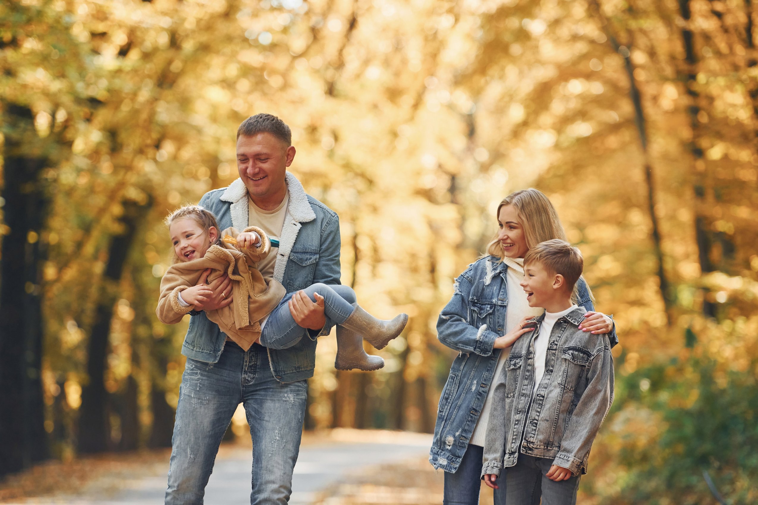 Family going for a walk in the October leaves