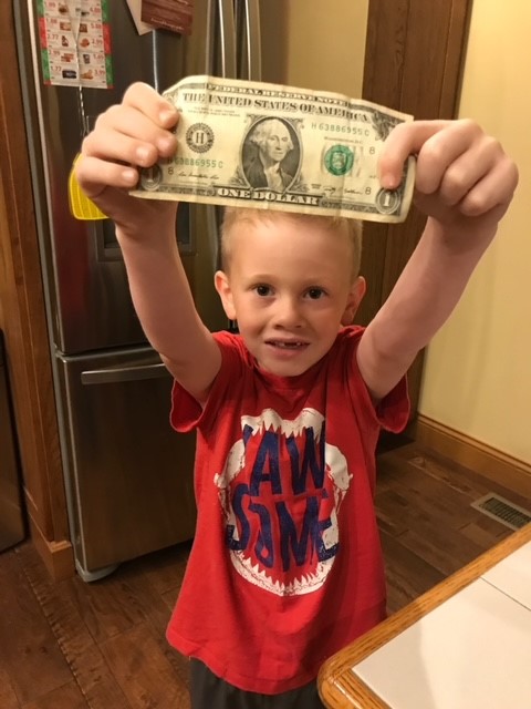child with dollar bill